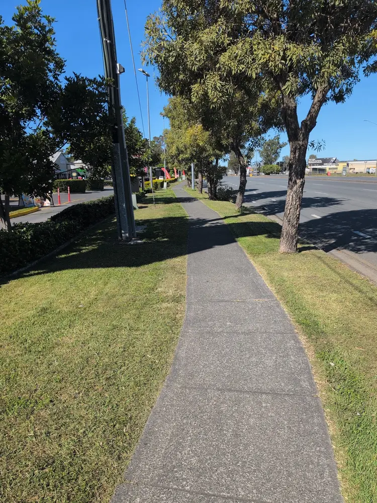 Roadside footpath with the grass on both sides mowed and the edges trimmed clean